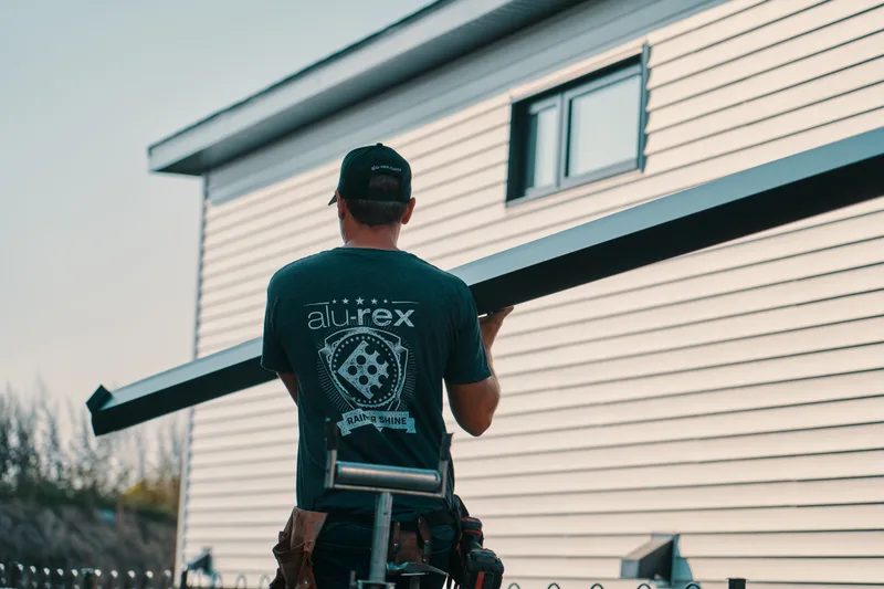 Installer working along the fascia board